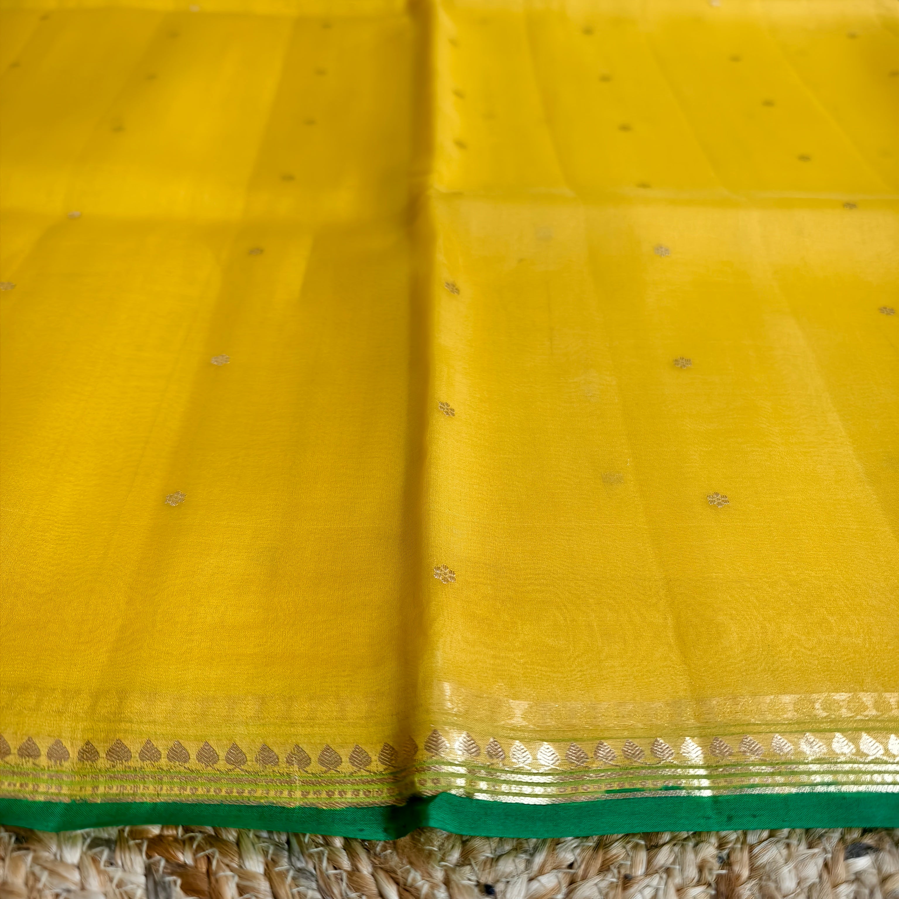 Vibrant yellow silk organza saree with bottle green small borders