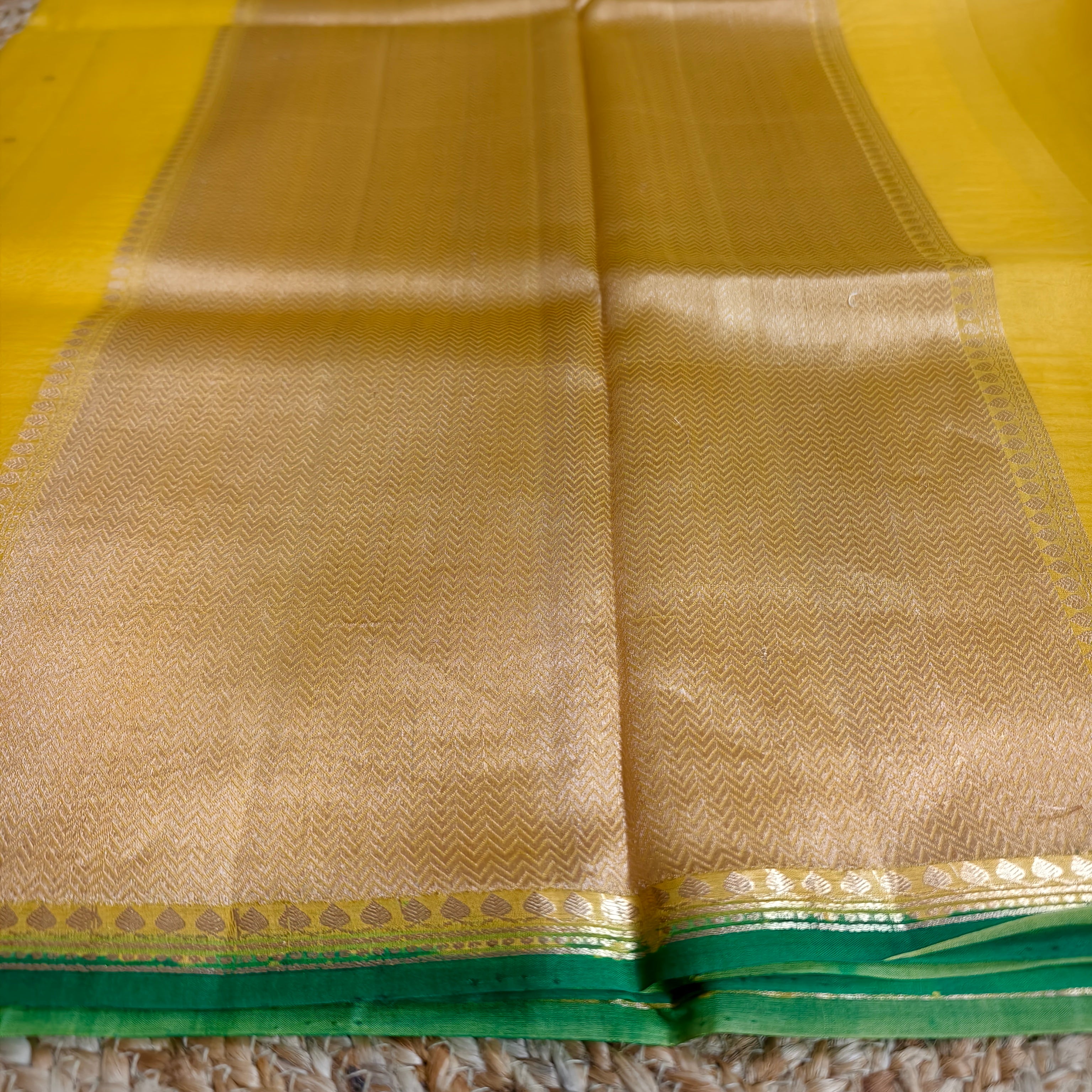 Vibrant yellow silk organza saree with bottle green small borders