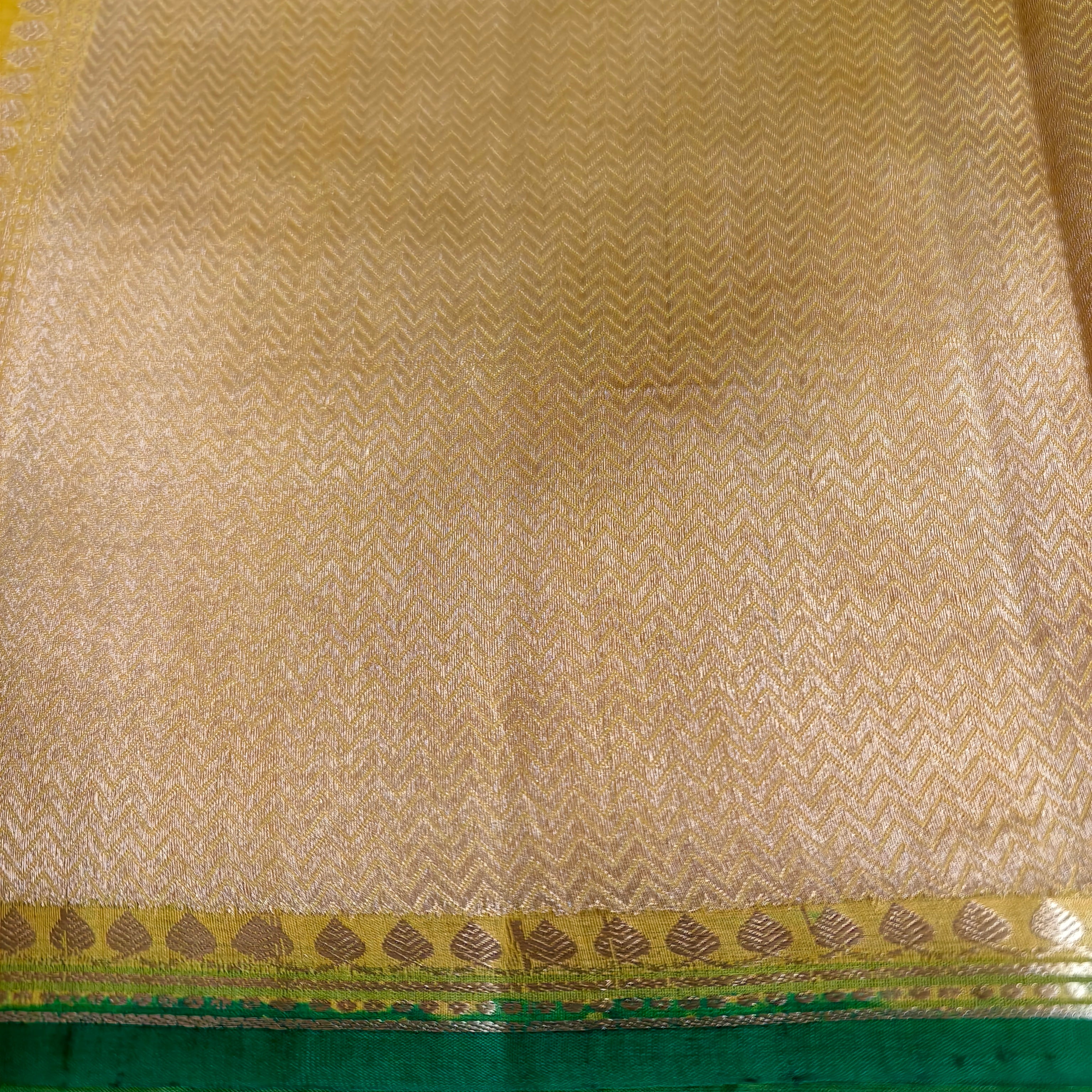 Vibrant yellow silk organza saree with bottle green small borders