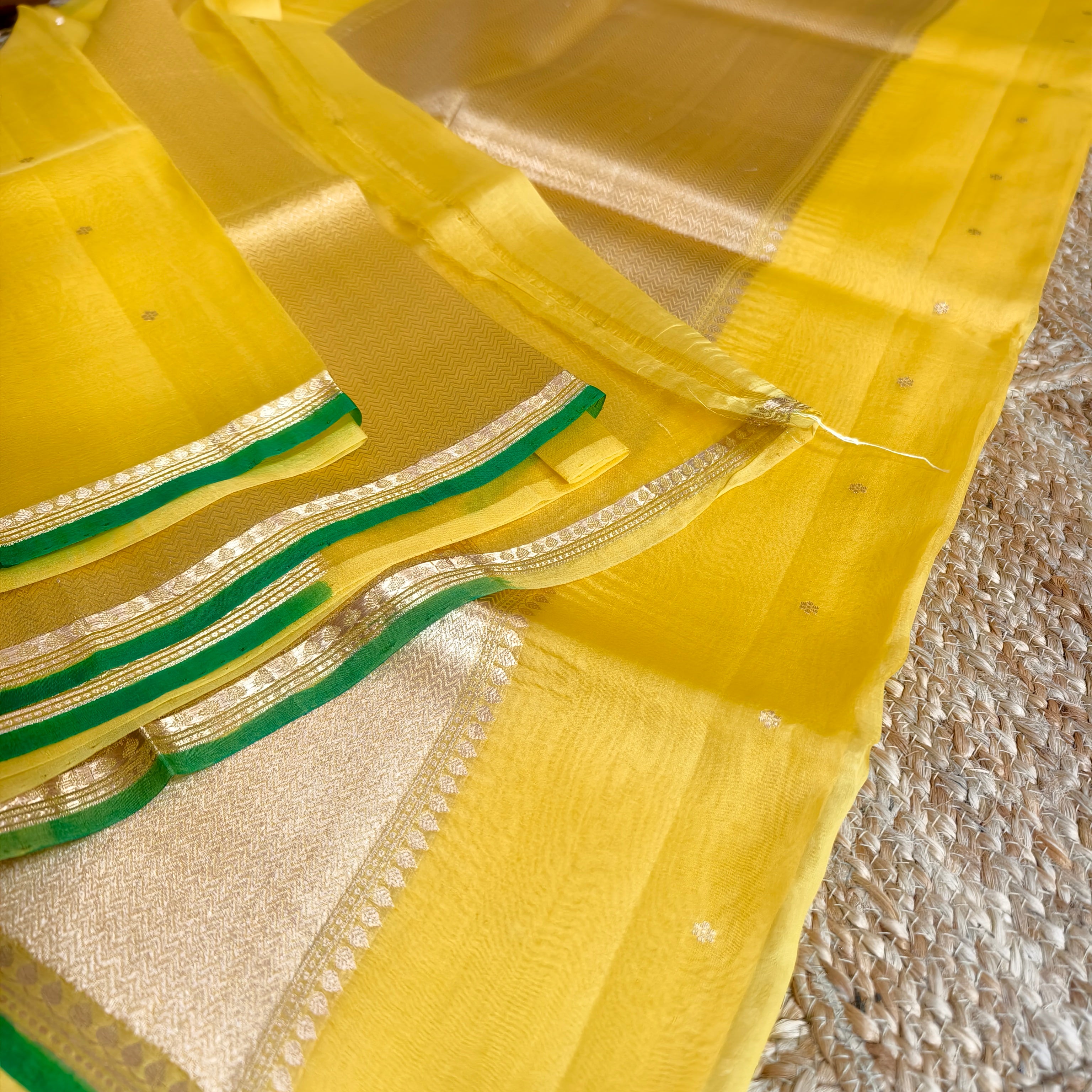 Vibrant yellow silk organza saree with bottle green small borders