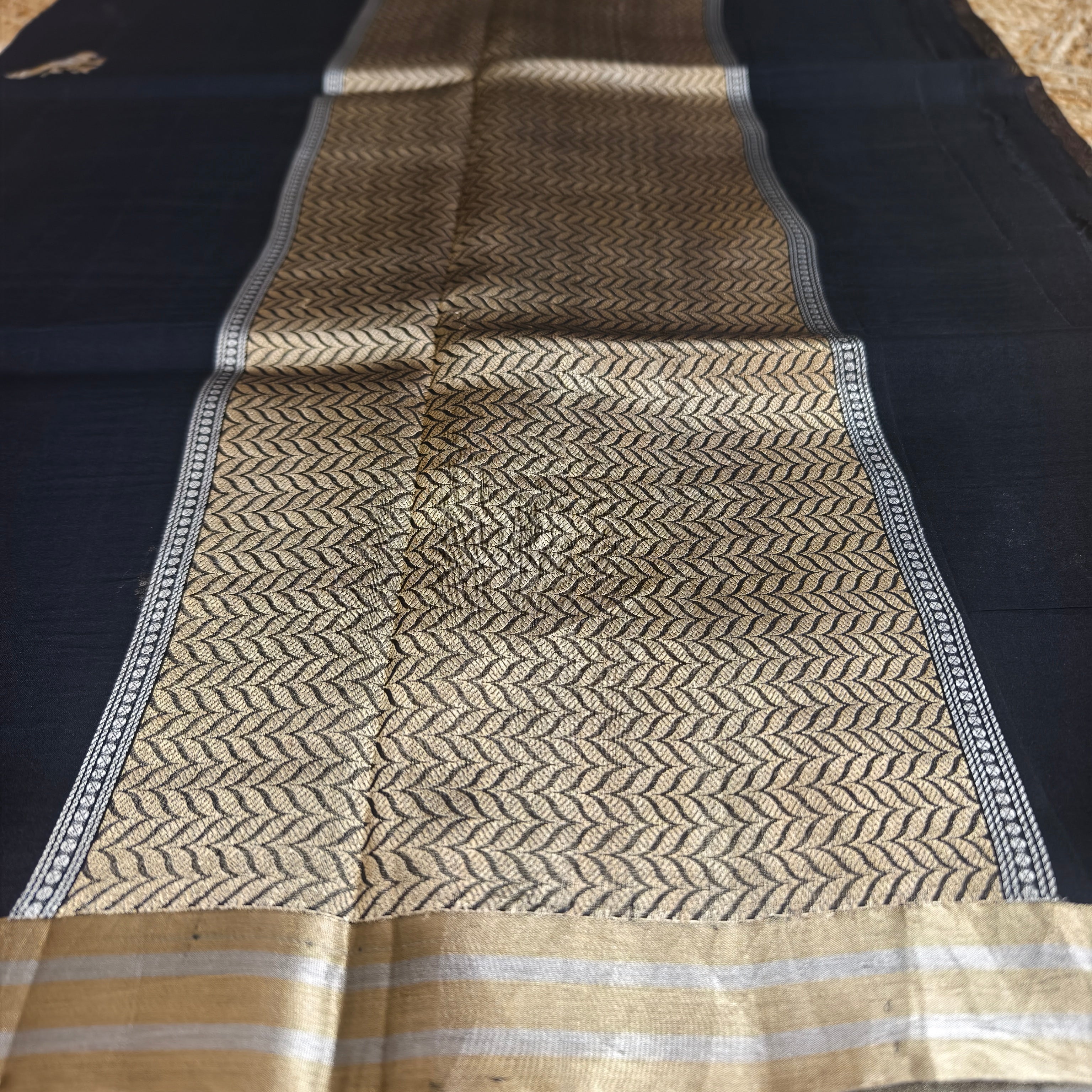 Black silk organza saree with small bird shaped weaving