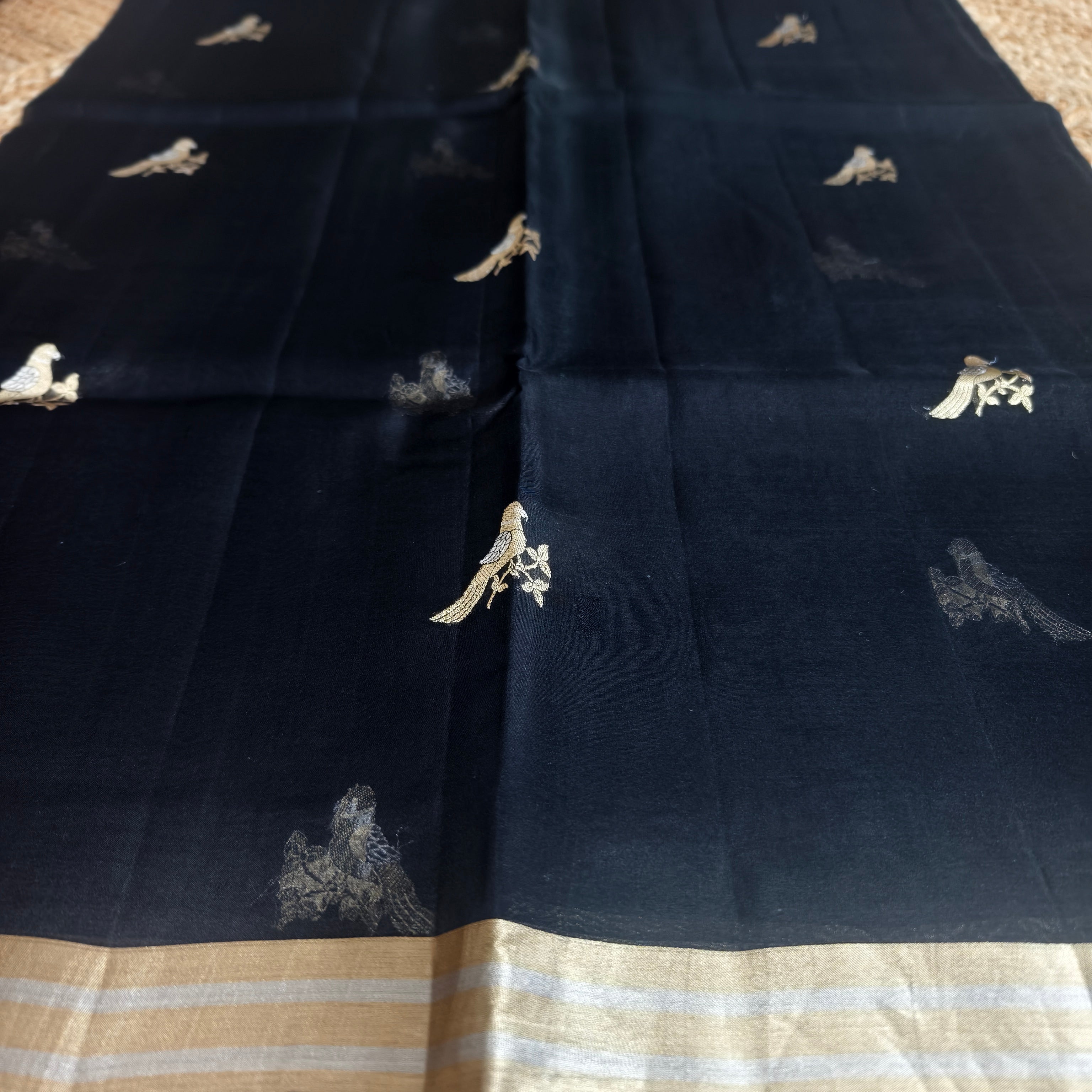 Black silk organza saree with small bird shaped weaving