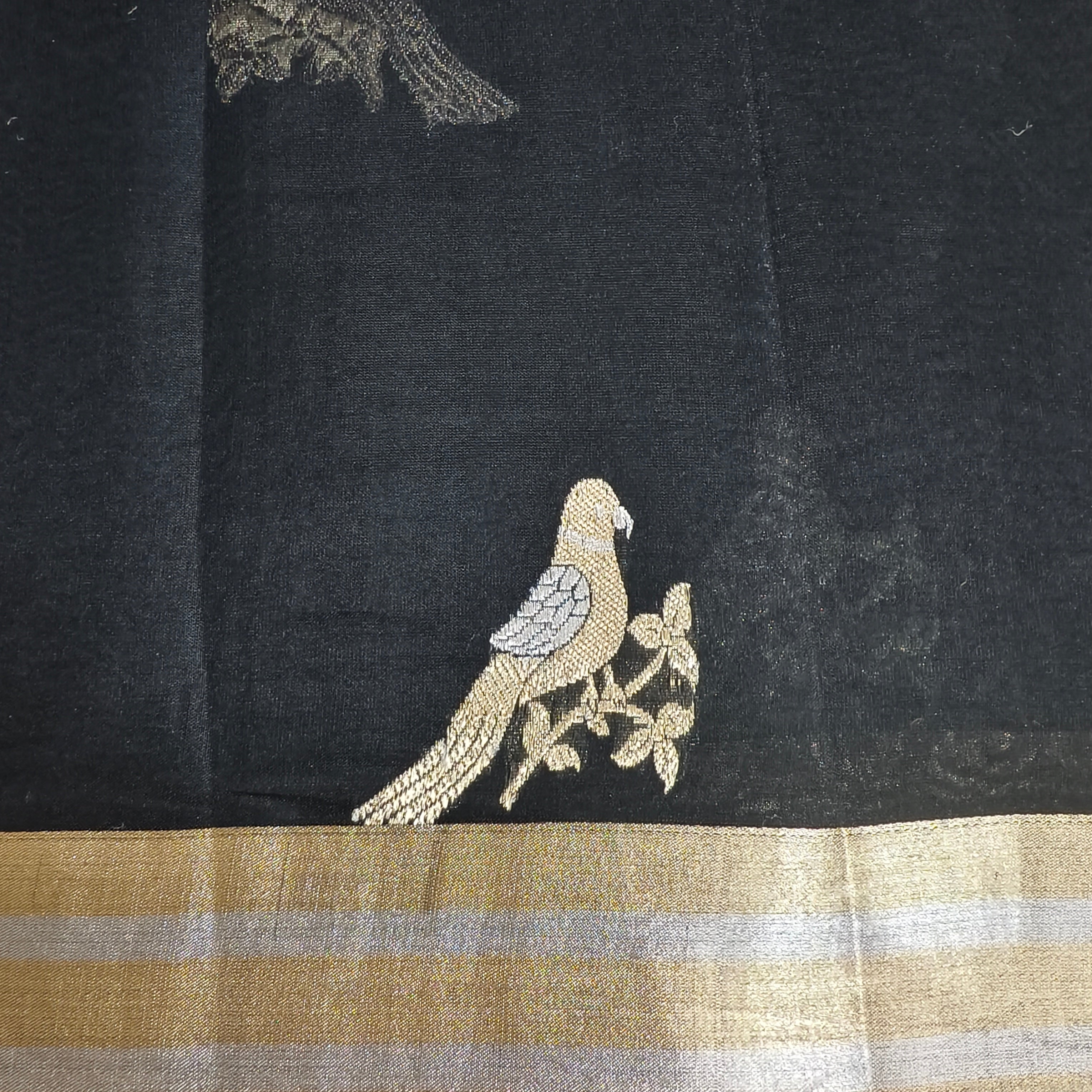 Black silk organza saree with small bird shaped weaving