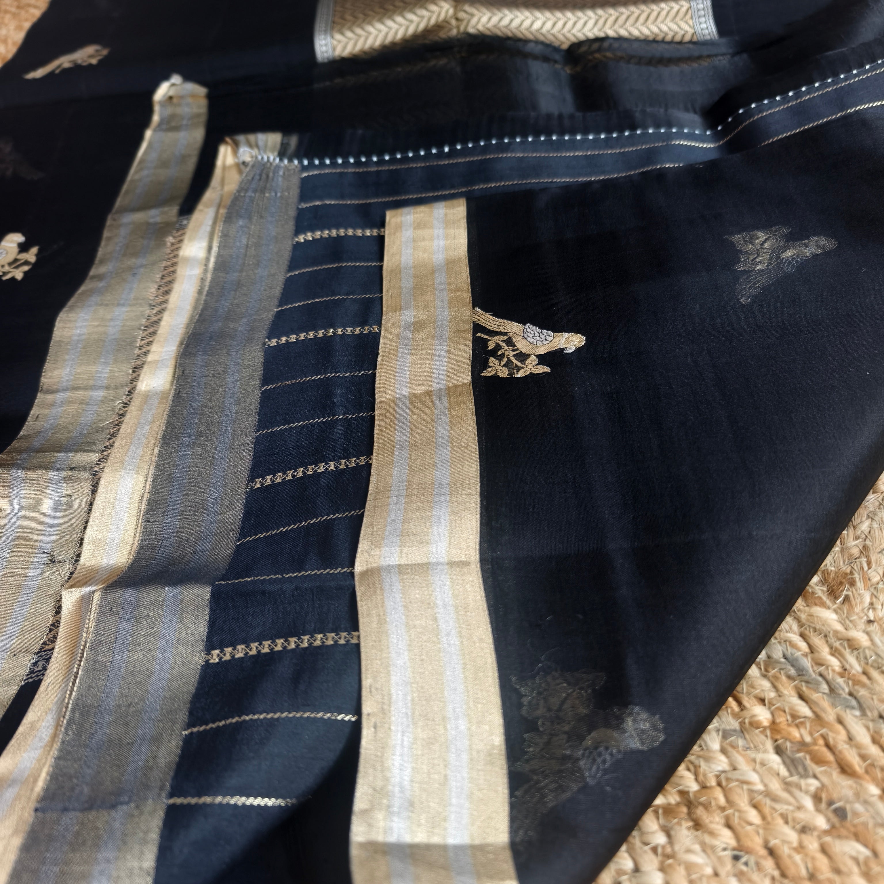 Black silk organza saree with small bird shaped weaving