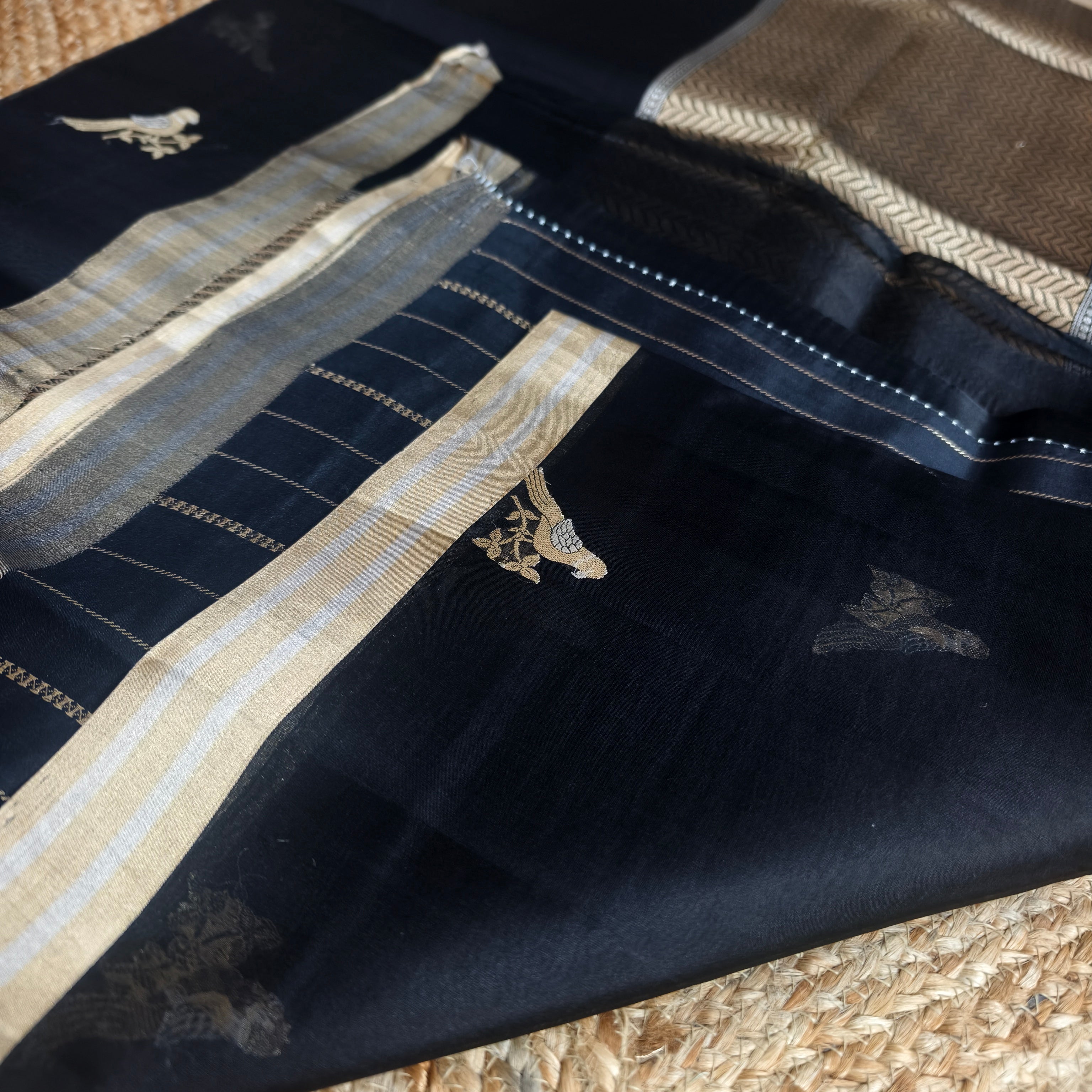 Black silk organza saree with small bird shaped weaving