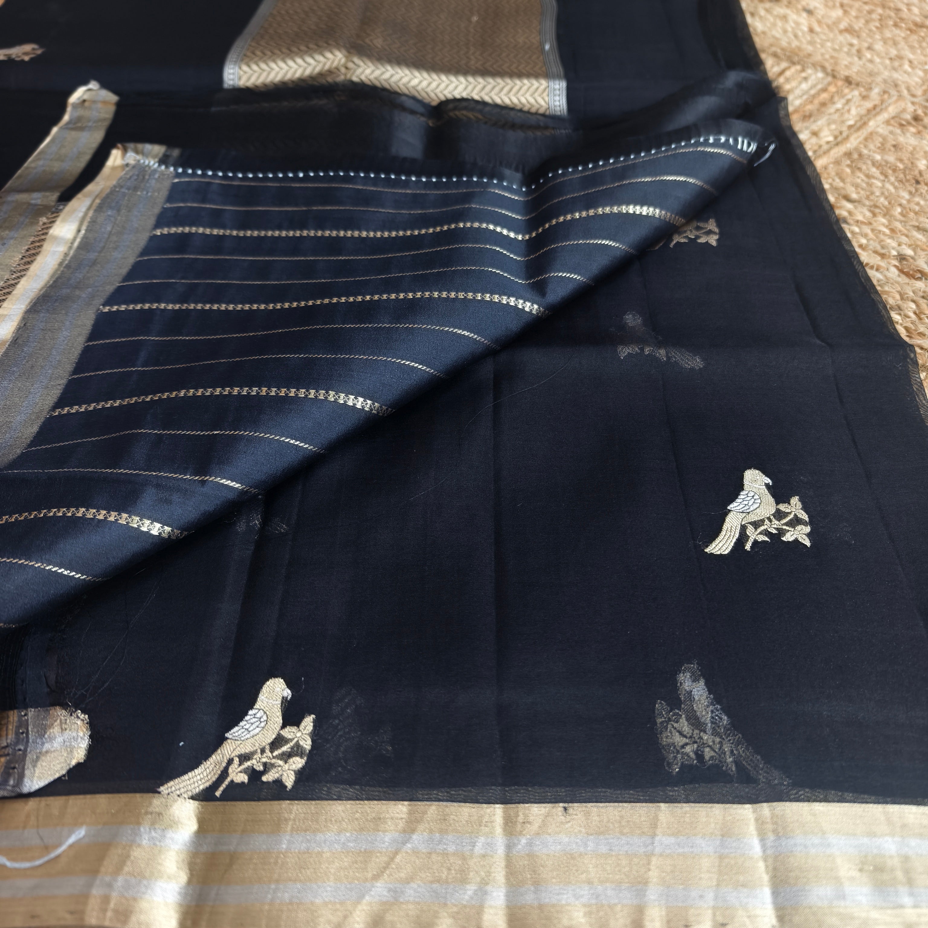 Black silk organza saree with small bird shaped weaving